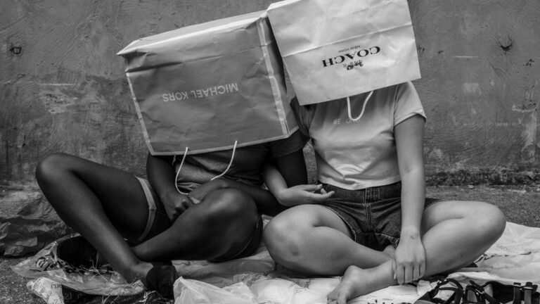 Two girls sitting on the floor.